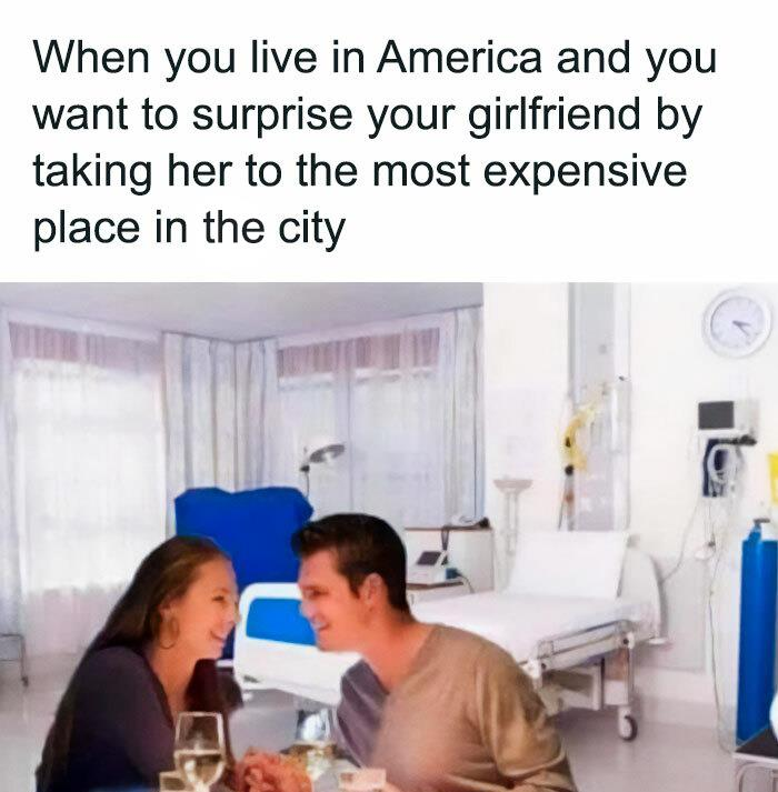 A couple sits at a dinner table in what appears to be a hospital room. They are smiling at each other, holding hands, with dinner plates and wine glasses in front of them. The text above reads: "When you live in America and you want to surprise your girlfriend by taking her to the most expensive place in the city.