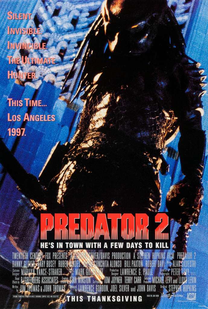The movie poster for "Predator 2" features a menacing, armored Predator holding a weapon, with the tagline "He's in town with a few days to kill." Text highlights the location as Los Angeles in 1997. The background has a dark, ominous tone with cityscape elements.