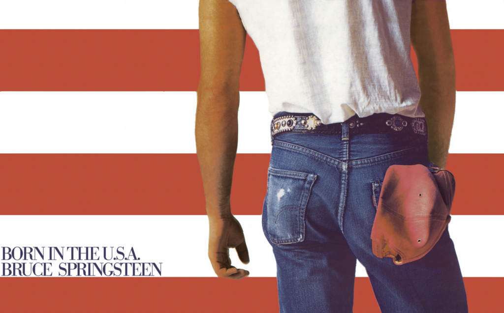 The image shows a person standing with their back turned, wearing a white T-shirt and blue jeans, with a red cap in their back pocket. The background consists of red and white horizontal stripes. Text at the bottom left reads: "BORN IN THE U.S.A. BRUCE SPRINGSTEEN.