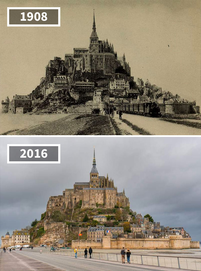 A split-image comparison of Mont-Saint-Michel, France, showing a black and white photo from 1908 on top and a colored photo from 2016 below. The iconic abbey and surrounding structures appear largely unchanged, though the area has modernized and is more developed with paved walkways.