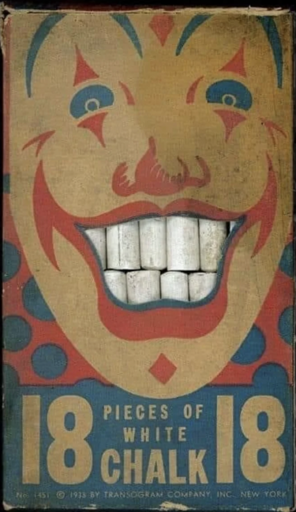 A vintage box of white chalk with an illustration of a smiling clown on the front. The clown's mouth is cut out, revealing the white chalk pieces inside, mimicking teeth. The text reads "18 Pieces of White Chalk" and lists a 1933 copyright from Transogram Company, Inc. New York.