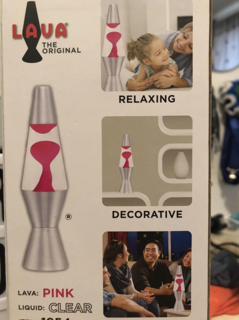 Product packaging for a Lava brand pink and clear lava lamp. The box features images of a family relaxing and a group of friends, emphasizing the lamp's uses for relaxation and decoration. There are also pictures of the lava lamp itself in different settings.