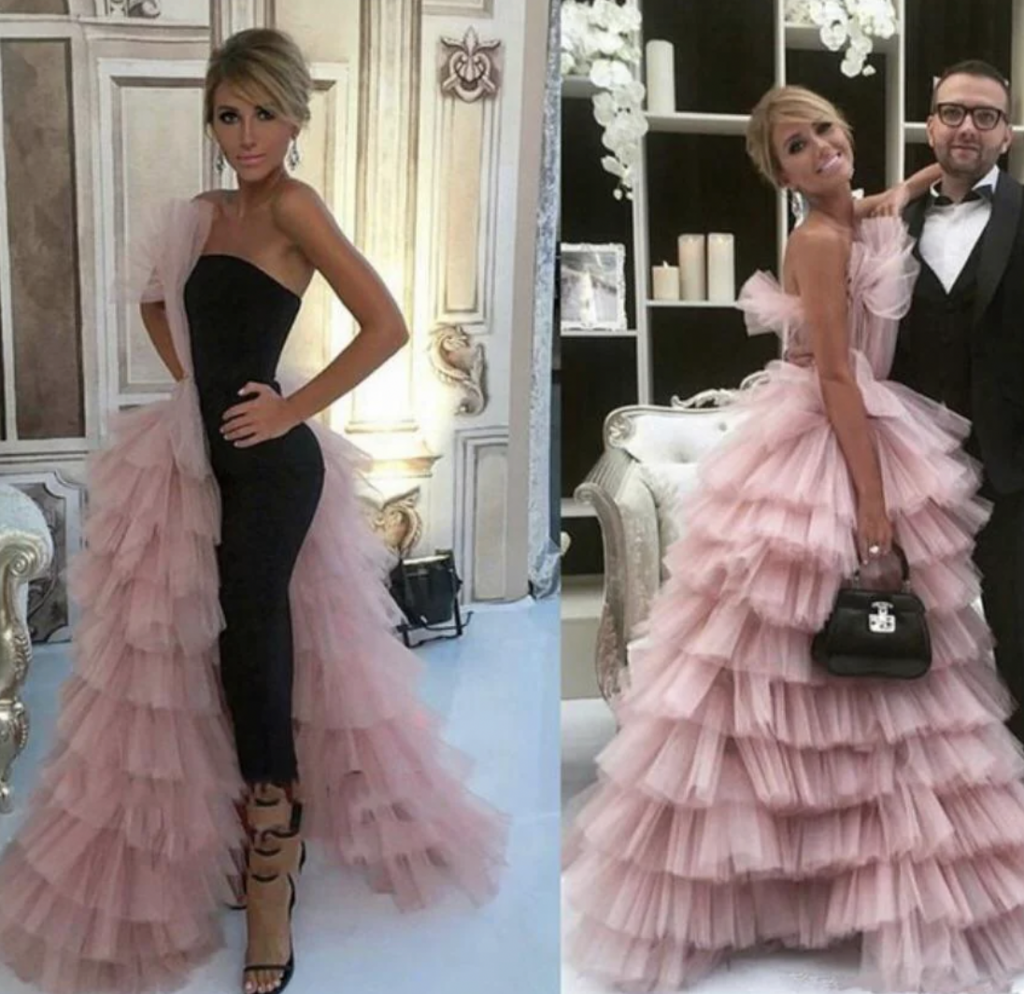 Two images of a woman in layered tulle outfits. Left: She wears a black jumpsuit with a ruffled tulle extension on one side and strappy heels. Right: She is in a pink layered tulle gown, holding a black handbag, posing with a man in a suit.