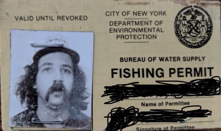 A fishing permit from the City of New York Department of Environmental Protection. The permit includes a black and white photo of a person with long hair and a mustache, along with a seal. Personal information appears to be redacted.