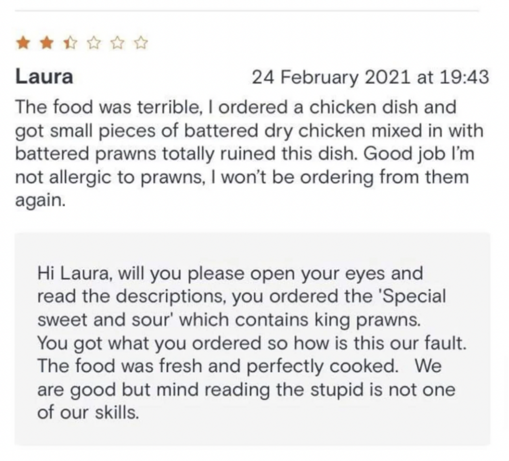 A screenshot of a negative restaurant review by Laura on 24 February 2021, stating that her chicken dish contained prawns and it ruined the meal. The restaurant's response insultingly clarifies she ordered "Special sweet and sour" with king prawns, not chicken.