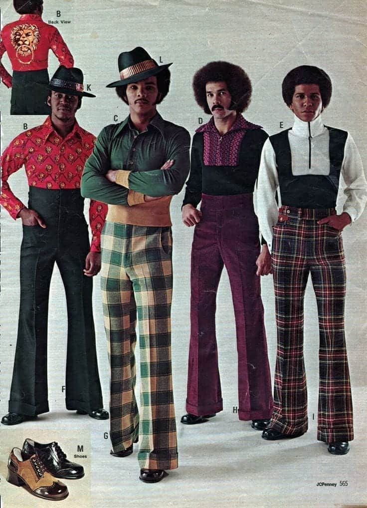 Four men wear 1970s fashion outfits featuring colorful patterns and flared pants. The first wears a red shirt and patterned pants, the second wears a striped jacket and plaid pants, the third wears a purple shirt and dark pants, and the fourth wears a vest and plaid pants.