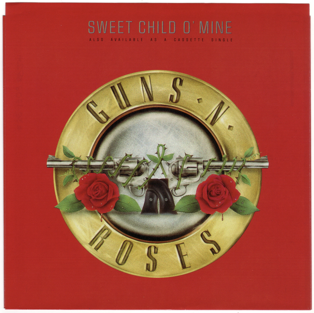 A red album cover featuring a metallic circular emblem with a pair of roses and a revolver. The text "GUNS N' ROSES" is wrapped around the circle, and "SWEET CHILD O’ MINE" along with "ALSO AVAILABLE AS A CASSETTE SINGLE" is written above it.