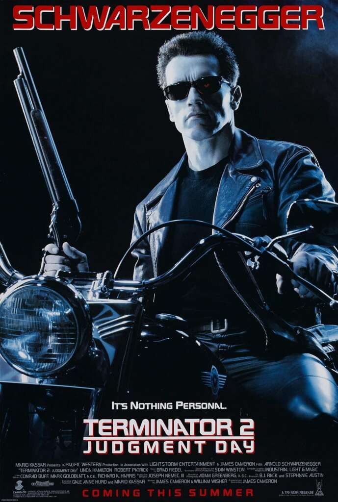 Movie poster for "Terminator 2: Judgment Day" featuring a leather-clad Arnold Schwarzenegger as the Terminator, holding a shotgun, and sitting on a motorcycle. Bold red text at the top reads "Schwarzenegger," with "Terminator 2: Judgment Day" below.