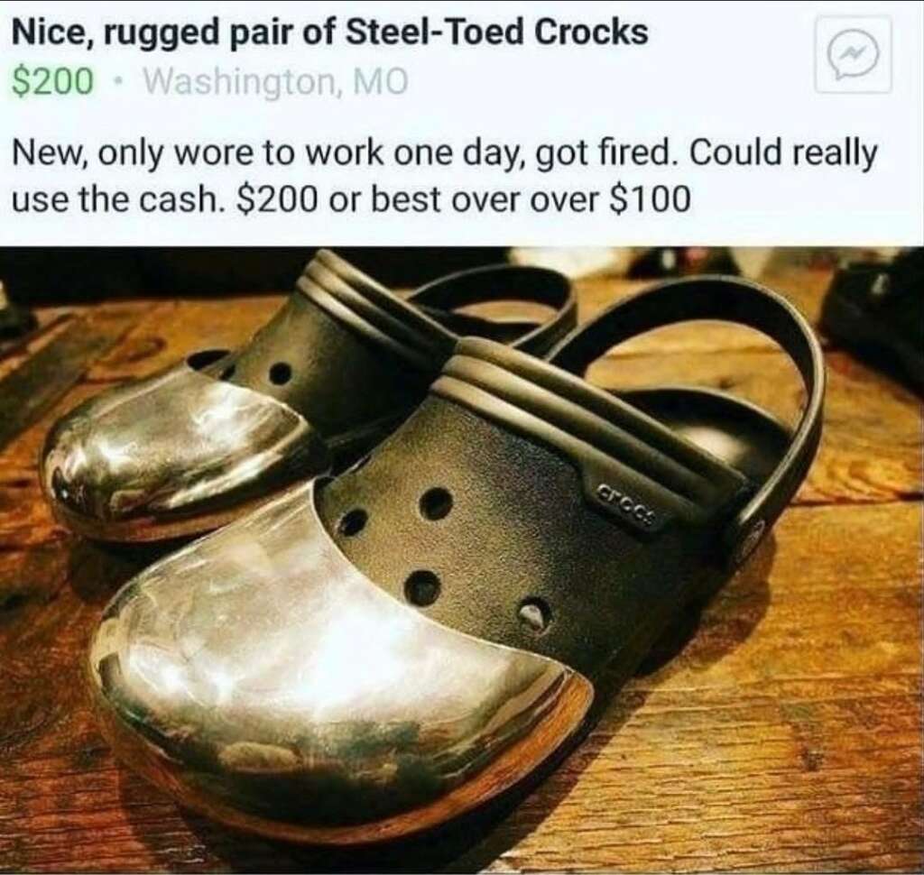 A pair of black Crocs with steel-toed fronts are displayed on a wooden surface. The image includes text stating they are new, only worn once to work before the seller got fired, and are being offered for sale for $200 or best offer over $100.