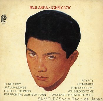 The album cover features an illustration of a young man with short black hair against a light background. The text at the top reads "Paul Anka / Lonely Boy." Below the illustration, there are song titles including "Lonely Boy" and "You Belong to Me.