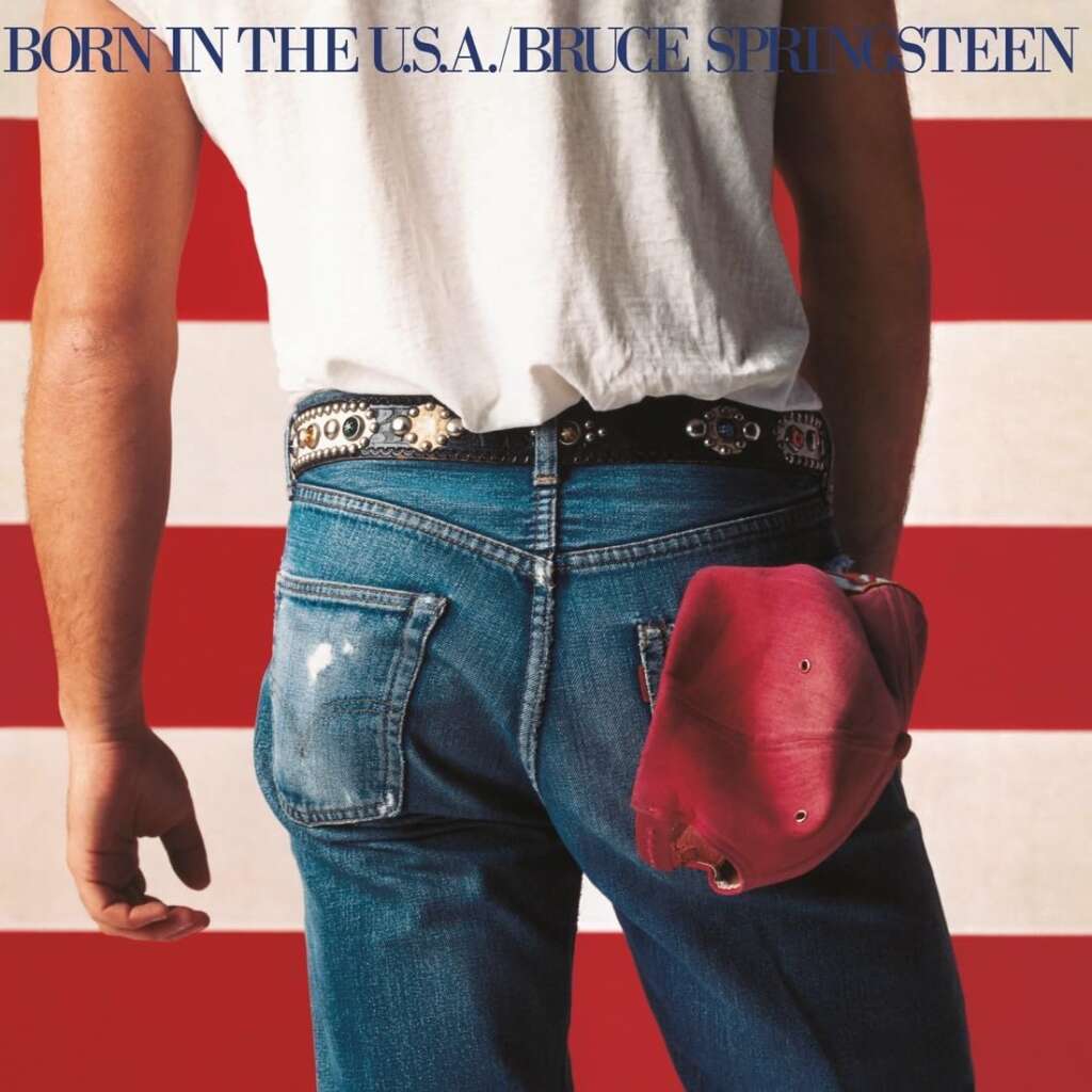 A person, shown from the waist down, wears blue jeans with a red baseball cap tucked into the back pocket. The background features bold red and white stripes. The text at the top reads "BORN IN THE U.S.A. / BRUCE SPRINGSTEEN.