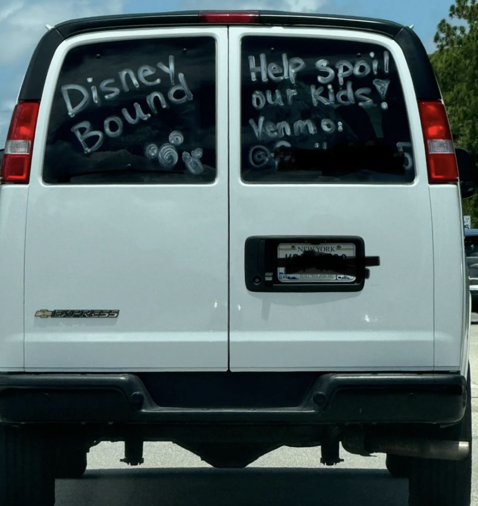 The back of a white van with messages written on the windows: "Disney Bound," "Help spoil our kids! Venmo: (username obscured)." The messages are decorated with small drawn images, including Mickey Mouse ears. The van has a New York license plate.