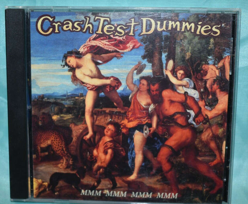 A CD album cover titled "Crash Test Dummies" featuring classical renaissance-style artwork with mythological figures. The bottom of the cover displays the text "MMM MMM MMM MMM". The background is a vibrant landscape with various characters.