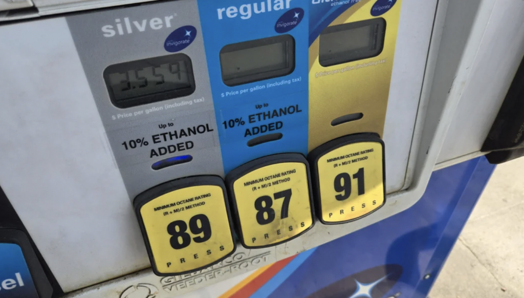 Close-up of a gas pump showing three fuel options: "Silver" (89 octane) priced at $3.54 per gallon, "Regular" (87 octane), and "Gold" (91 octane). All fuel options have up to 10% ethanol added.