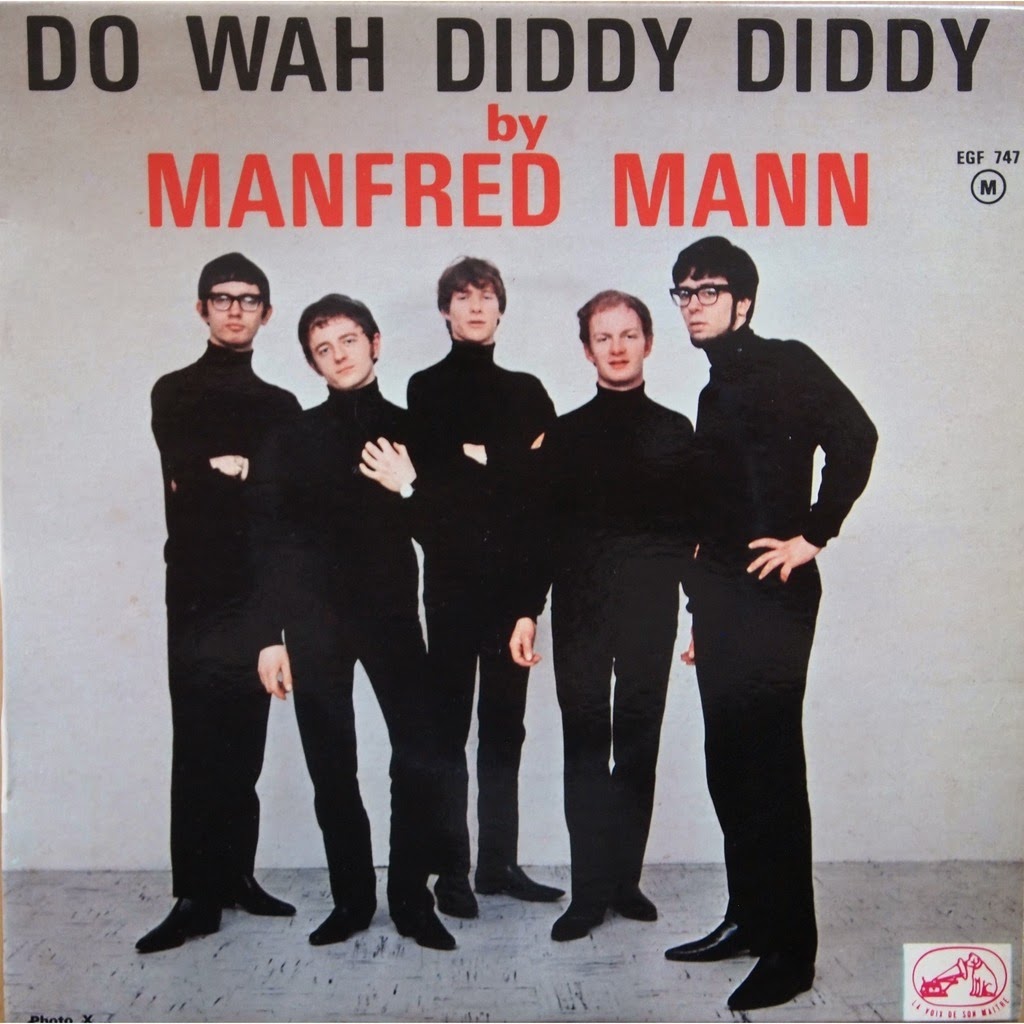 Album cover for "Do Wah Diddy Diddy" by Manfred Mann. The image features five men standing next to each other, all wearing black turtleneck sweaters and pants, against a plain, light-colored background. The title and band name appear in large, bold text above them.