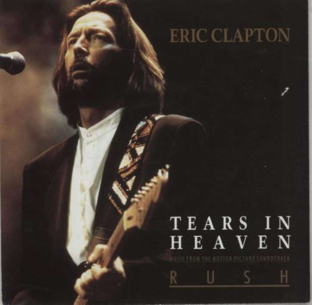 Album cover featuring a bearded man with long hair playing a guitar and singing into a microphone. The background is dark and the text reads "Eric Clapton" at the top right, and "Tears in Heaven: Music from the Motion Picture Soundtrack" at the bottom. Not visible: the word Rush.