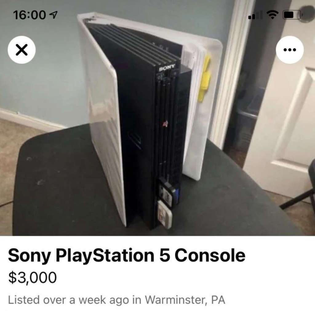 A black Sony PlayStation 2 console with memory cards inserted is housed inside a white binder. The image is from an online listing that mistakenly labels it as a "Sony PlayStation 5 console" priced at $3,000. The listing was posted in Warminster, PA.