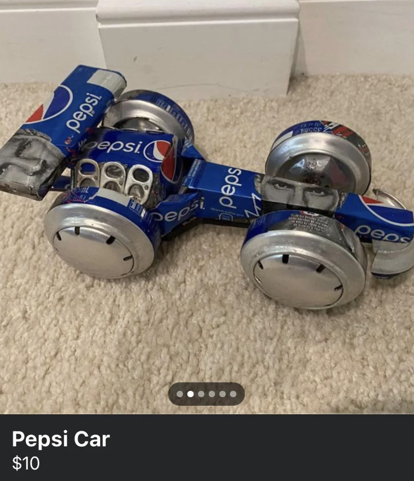 A small car model made out of empty Pepsi cans and bottle caps is displayed on a beige carpet. The crafted car is labeled "Pepsi Car" and priced at $10.