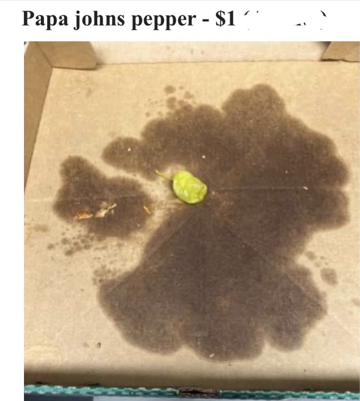 An empty pizza box with a single pepperoncini pepper and some dark grease stains. The image includes a partial heading that reads "Papa johns pepper - $1".