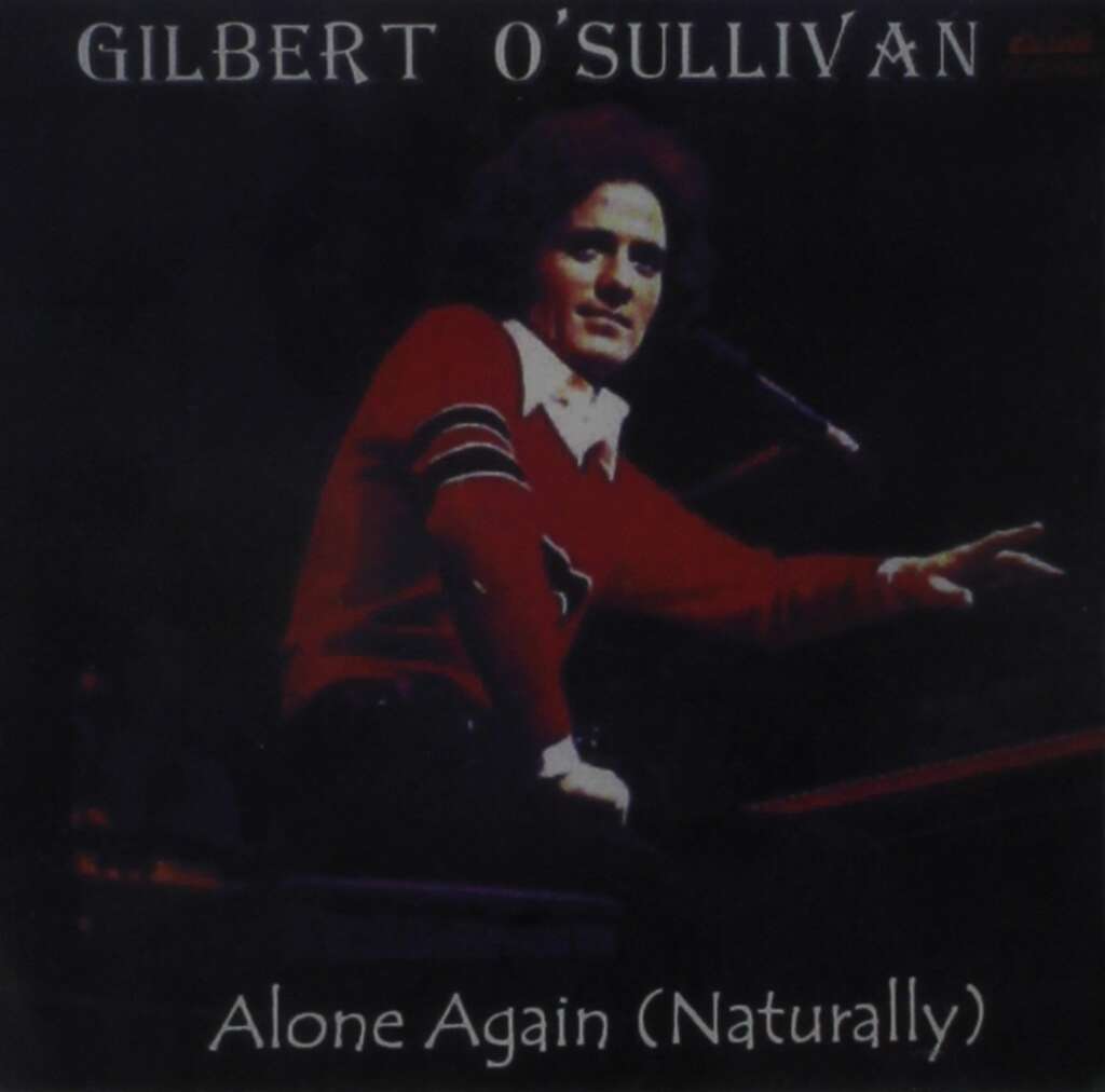 Album cover of "Alone Again (Naturally)" by Gilbert O'Sullivan, featuring a man with curly hair wearing a red sweater, sitting at a piano, and gesturing with his right hand. White text displays the artist's name at the top and the song title at the bottom.