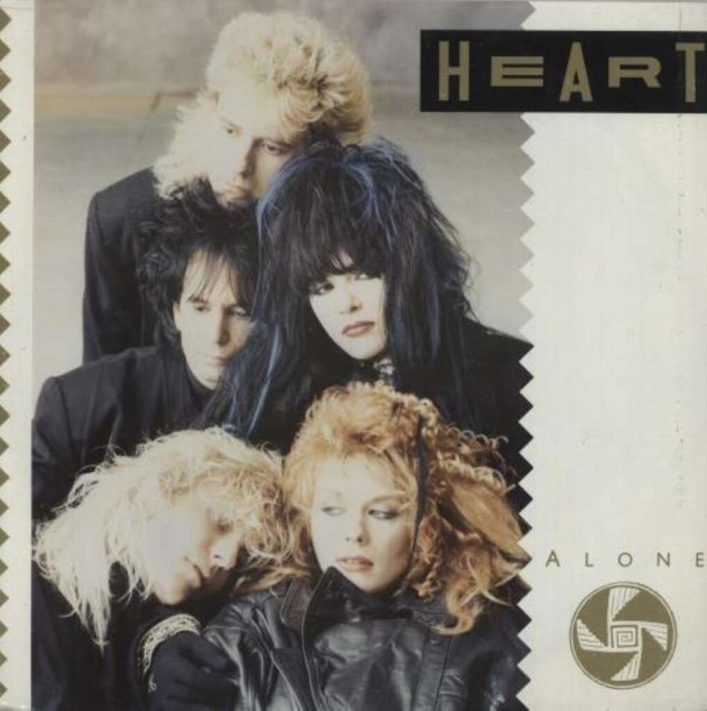 Album cover featuring the band Heart for the single "Alone". The image shows five members with dramatic, teased hair and dark makeup in 1980s style. They are positioned closely together, looking in different directions, with the band's name and the song title on the top right.