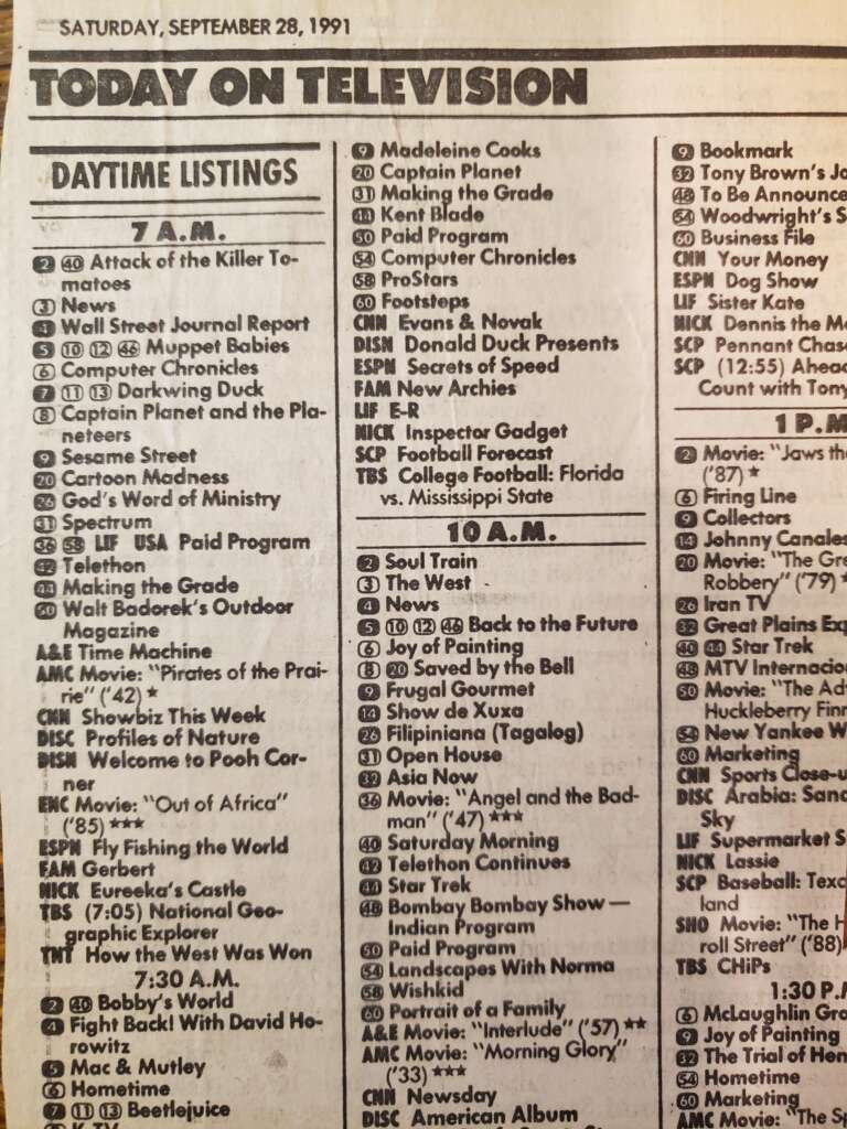 A vintage TV guide listing for Saturday, September 28, with daytime TV show schedules. Highlights include "Attack of the Killer Tomatoes," "Muppet Babies," "Looney Tunes," "Inspector Gadget," and "Football." Shows are categorized by time slots and networks.