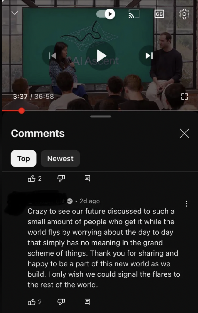 Screenshot of a YouTube video with the title "AI Ascent." The video is paused at 3:37, and shows a man and a woman speaking on a panel. Below, a comment reads: "Crazy to see our future discussed to such a small amount of people who get it while the world flies by worrying about the day to day that simply has no meaning in the grand scheme of things. Thank you for sharing and happy to be a part of this new world as we build. I only wish we could signal the flares to the rest of the world.