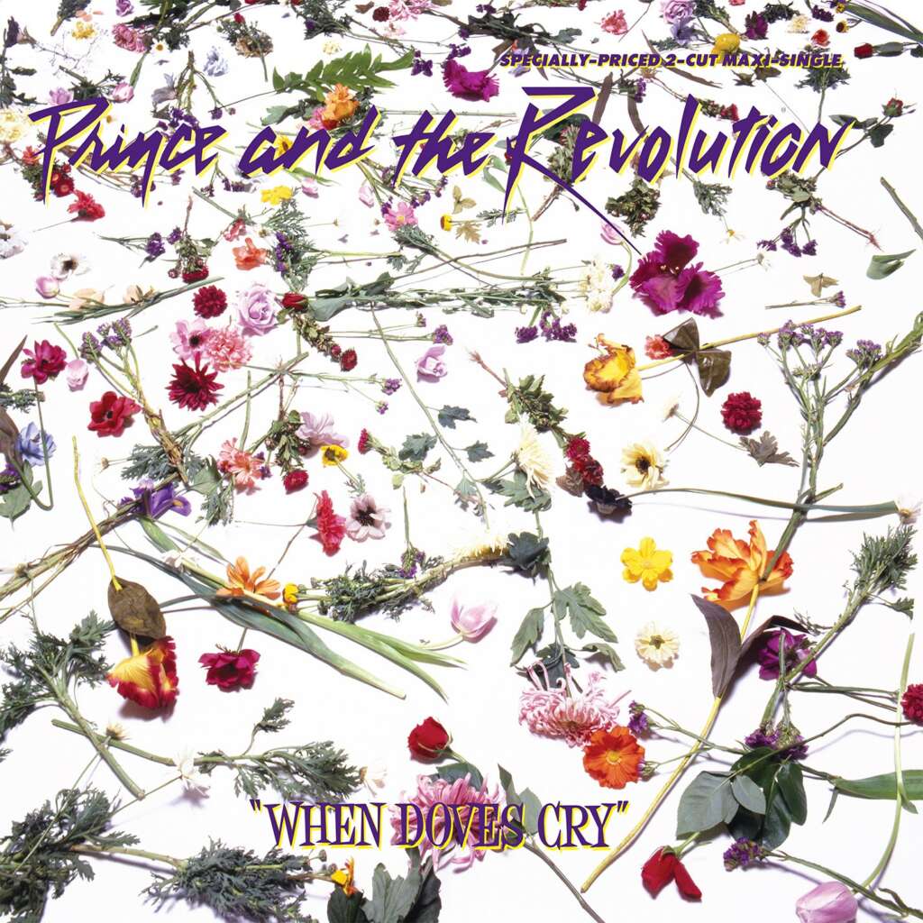 Album cover for "When Doves Cry" by Prince and the Revolution. The background shows an artistic arrangement of various colorful flowers scattered across a white surface. The band's name is written in a purple stylized font at the top, and the song title is at the bottom.