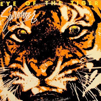 Illustrated album cover showing the face of a tiger with intense yellow eyes, set against an orange and black background. The text "EYE OF THE TIGER" is displayed at the top in bold, yellow letters, and "Survivor" is written in a stylized script.