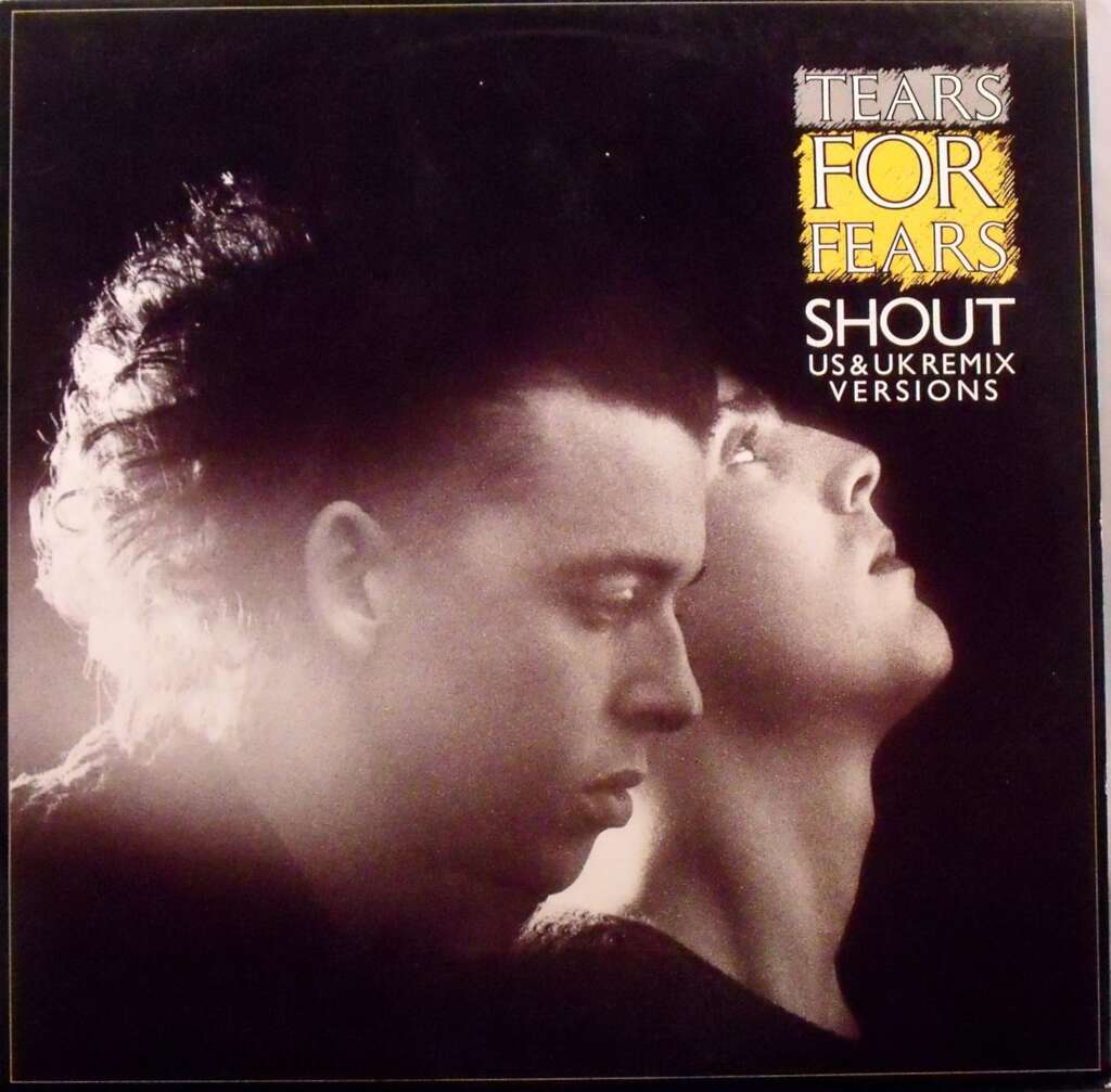 A black and white image features two individuals; one with a punk-style hair leaning forward with eyes closed and the other looking upwards. The text reads: "Tears for Fears - Shout - US & UK Remix Versions" in bold letters.