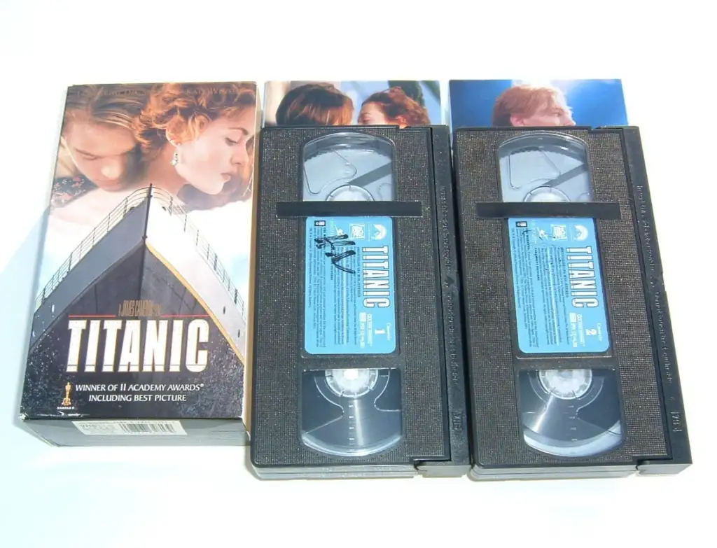A boxed set of two Titanic VHS tapes. The box features the Titanic ship with images from the film, including the main characters. The text on the box mentions winning 11 Academy Awards, including Best Picture. The VHS tapes are labeled Titanic 1 and Titanic 2.