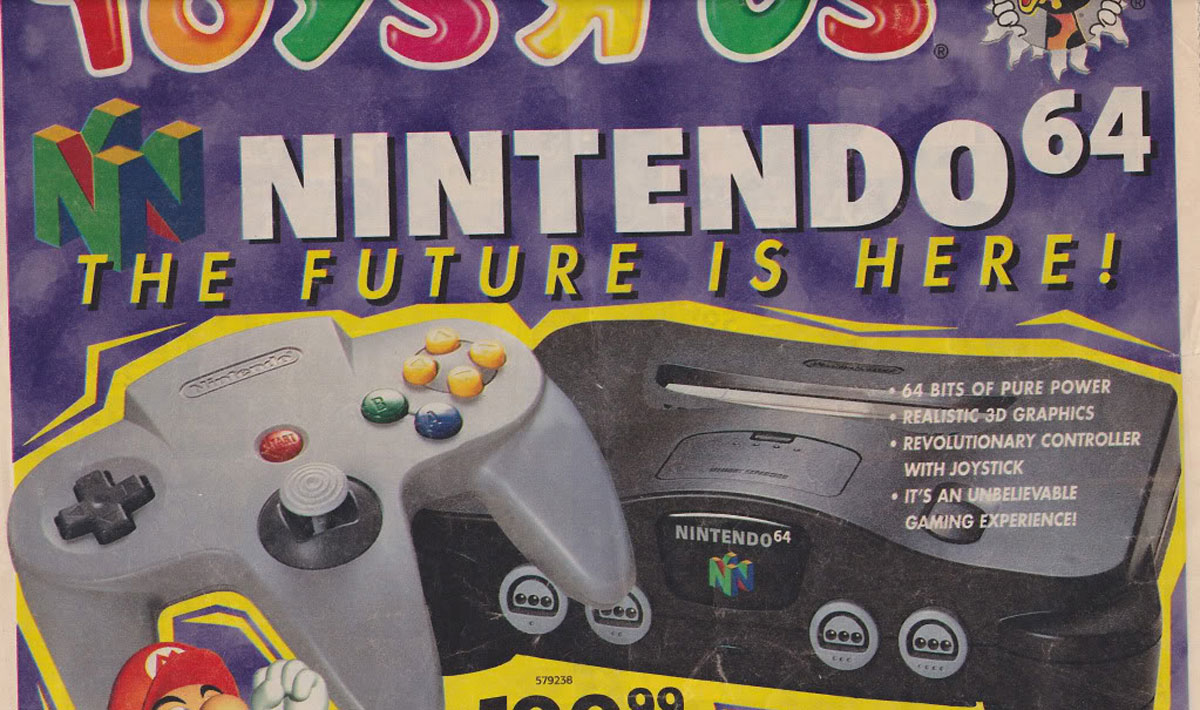 A vintage Toys R Us advertisement for the Nintendo 64. The colorful ad features the console and the controller prominently, with text highlighting "64 Bits of Pure Power," "Realistic 3D Graphics," and promoting it as "An Unbelievable Gaming Experience!" The price is $149.99.