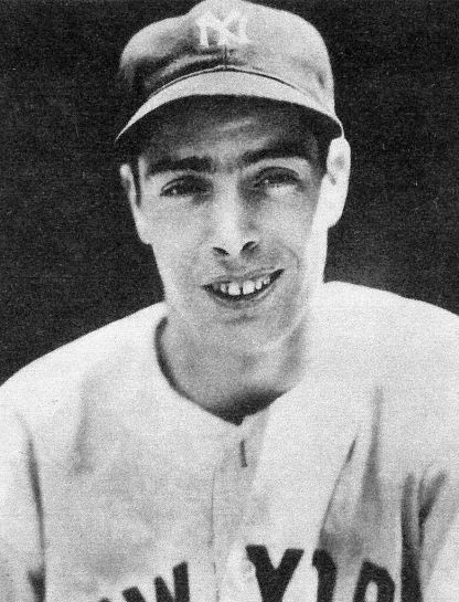 A black-and-white photograph of a baseball player wearing a cap with the letter 'N' and 'Y' and a jersey with the words "New York." The player is smiling and looking directly at the camera.