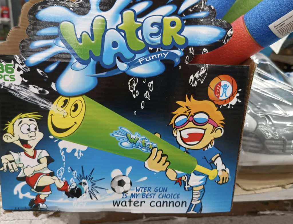 A colorful cardboard box displaying a toy water cannon shaped like a baseball bat. The box has playful cartoon characters: a kid spraying water from the cannon and another kid being hit by the water. The text reads "Water Funny" and "Water gun is my best choice water cannon.