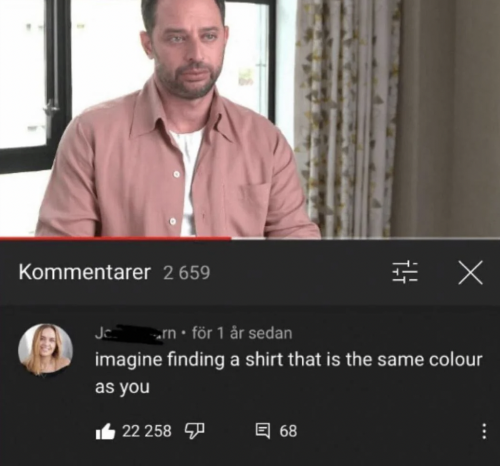 A man, wearing a light pink shirt, is seen on a television screen. Beneath the screen is a comment section displaying a comment that reads, "imagine finding a shirt that is the same colour as you," with 22,258 likes and 68 replies.