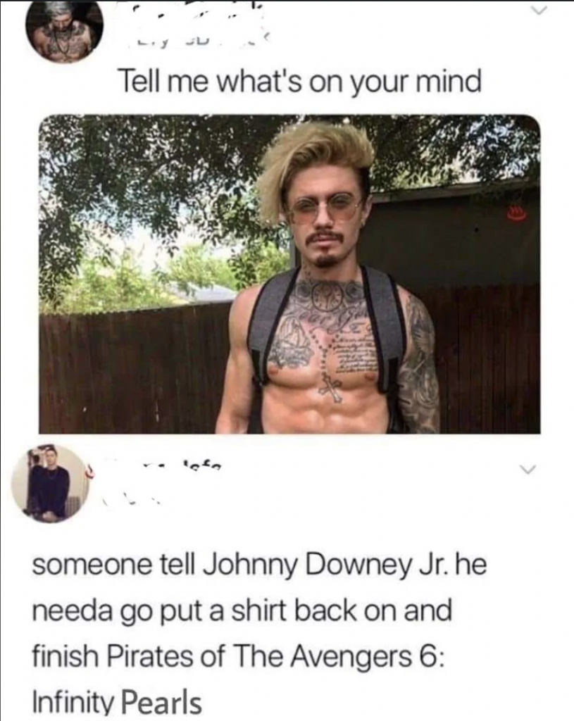 A shirtless, tattooed man with sunglasses and a backpack stands outdoors, under a caption saying, "Tell me what's on your mind." Below, a comment humorously asks someone to tell "Johnny Downey Jr." to put a shirt on and finish "Pirates of The Avengers 6: Infinity Pearls.