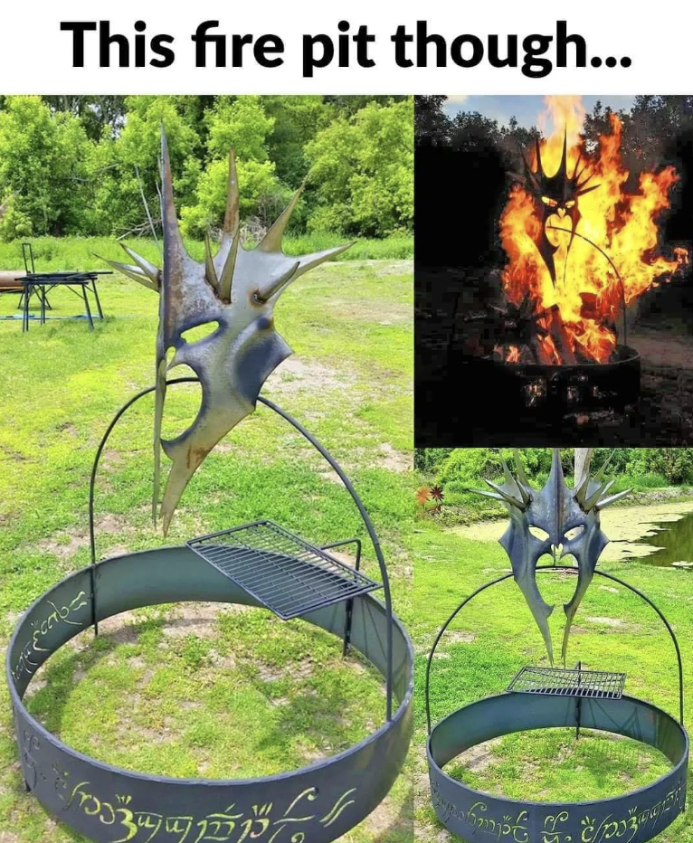 A metal fire pit designed with a spiky, horned mask motif and intricate runic-like engravings around the rim. Inset image shows the fire pit at night with flames blazing behind the mask, creating an illuminated, dramatic effect.