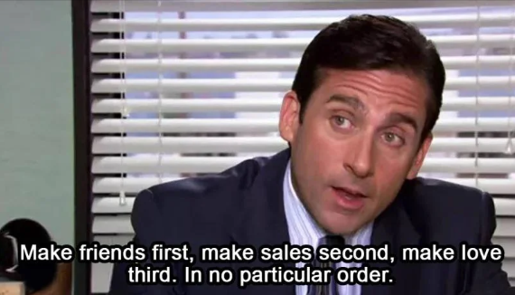 A man in a suit and tie is seated in an office next to a window with closed blinds. He is speaking and the caption reads, "Make friends first, make sales second, make love third. In no particular order.