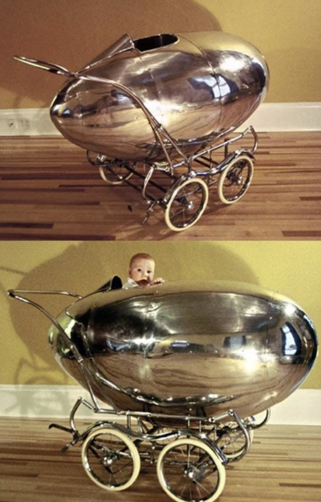 Top: A silver, retro-futuristic baby stroller with an egg-shaped body on a wooden floor.
Bottom: A baby peeking out from inside the same shiny, egg-shaped stroller, creating a whimsical scene.