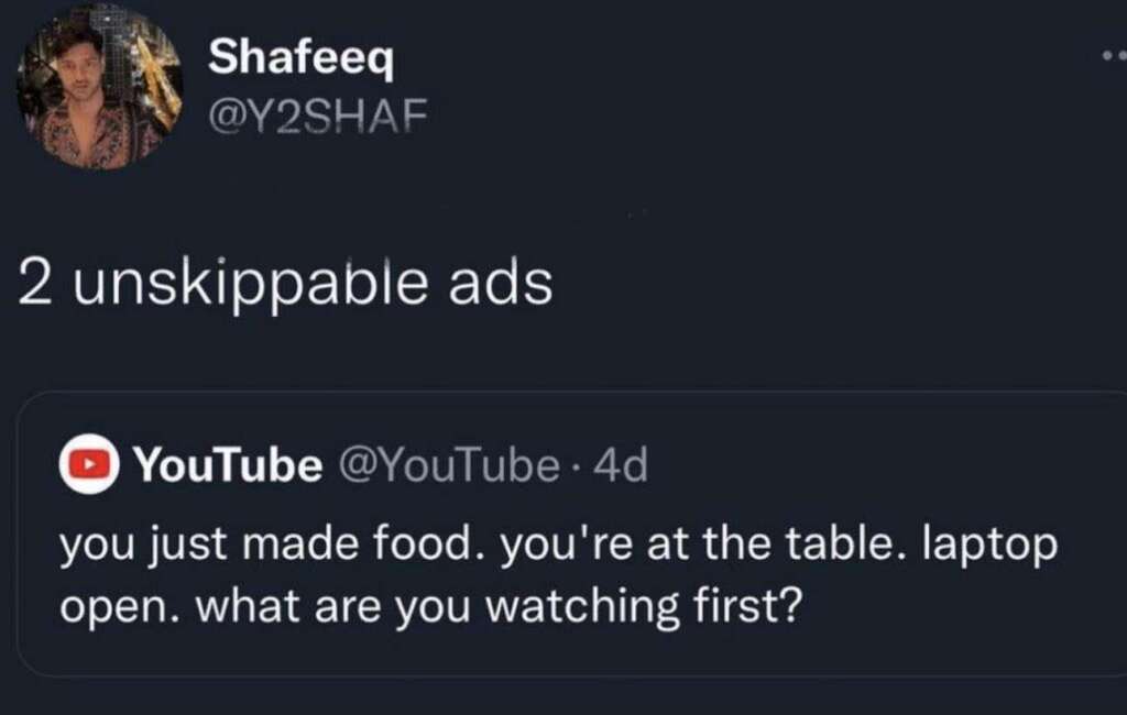 A social media post by a user named Shafeeq, with the handle @Y2SHAF, reads "2 unskippable ads" in response to a YouTube post saying, "you just made food. you're at the table. laptop open. what are you watching first?