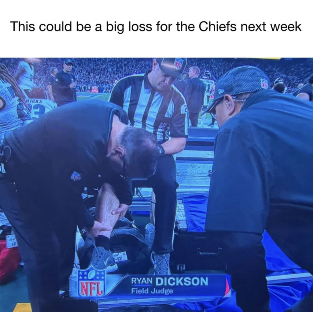 A football field judge identified as Ryan Dickson is getting medical attention on the sidelines. Two other officials are assisting him as he sits on a bench with his leg raised and being examined. The caption reads, "This could be a big loss for the Chiefs next week.