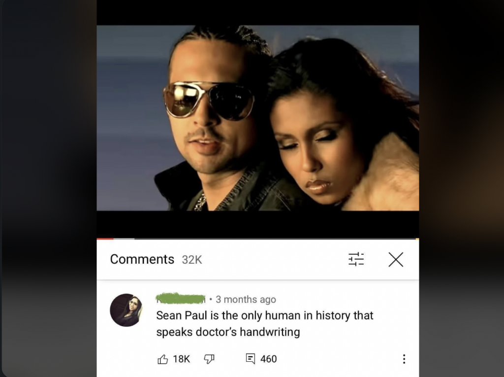 A music video screenshot shows a man wearing sunglasses and a woman close beside him. Below is a YouTube comment with 32K comments. The comment reads, "Sean Paul is the only human in history that speaks doctor's handwriting." It has 18K likes and 460 replies.