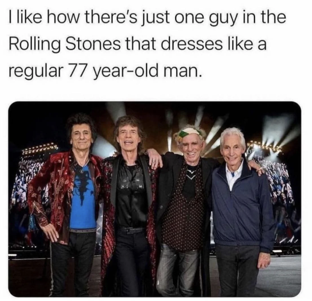 Four members of the Rolling Stones stand together on stage, wearing a mix of casual and vibrant outfits. One of them is dressed more conservatively, suitable for an older man, contrasting with the others' more flamboyant attire. A humorous caption is above them.