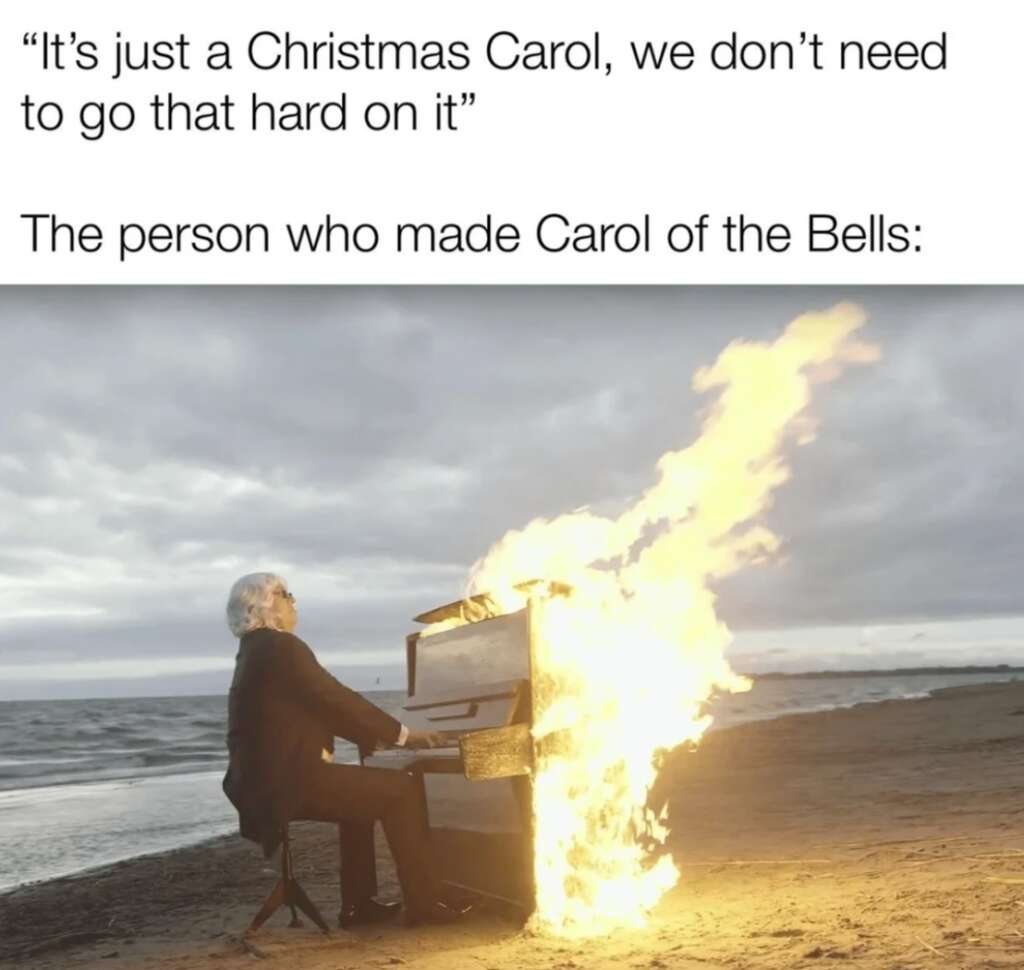 A person plays a piano engulfed in flames on a beach under a cloudy sky. The image includes text saying, "It's just a Christmas Carol, we don't need to go that hard on it," followed by "The person who made Carol of the Bells: