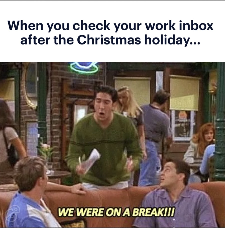 A man in a coffee shop passionately exclaims, "WE WERE ON A BREAK," to two seated people. The caption reads, "When you check your work inbox after the Christmas holiday..." It's a meme implying a chaotic return to work.