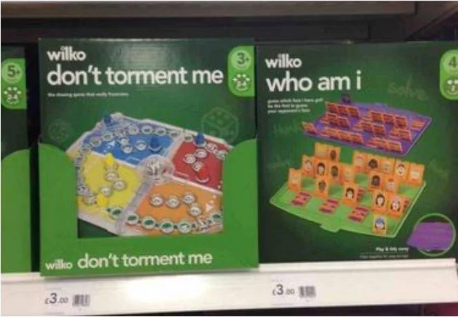 Two children's board games on a shelf. One is titled "don't torment me" with a colorful board, and the other is titled "who am I" with a guessing board featuring faces. Both are priced at £3.00.