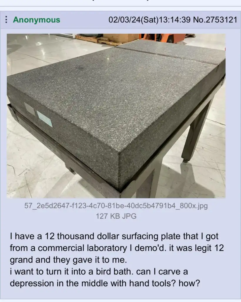 A large, gray surface plate is placed on a metal stand in a laboratory setting. It has a smooth texture, with a visible corner edge. A paper with text is visible below the image.