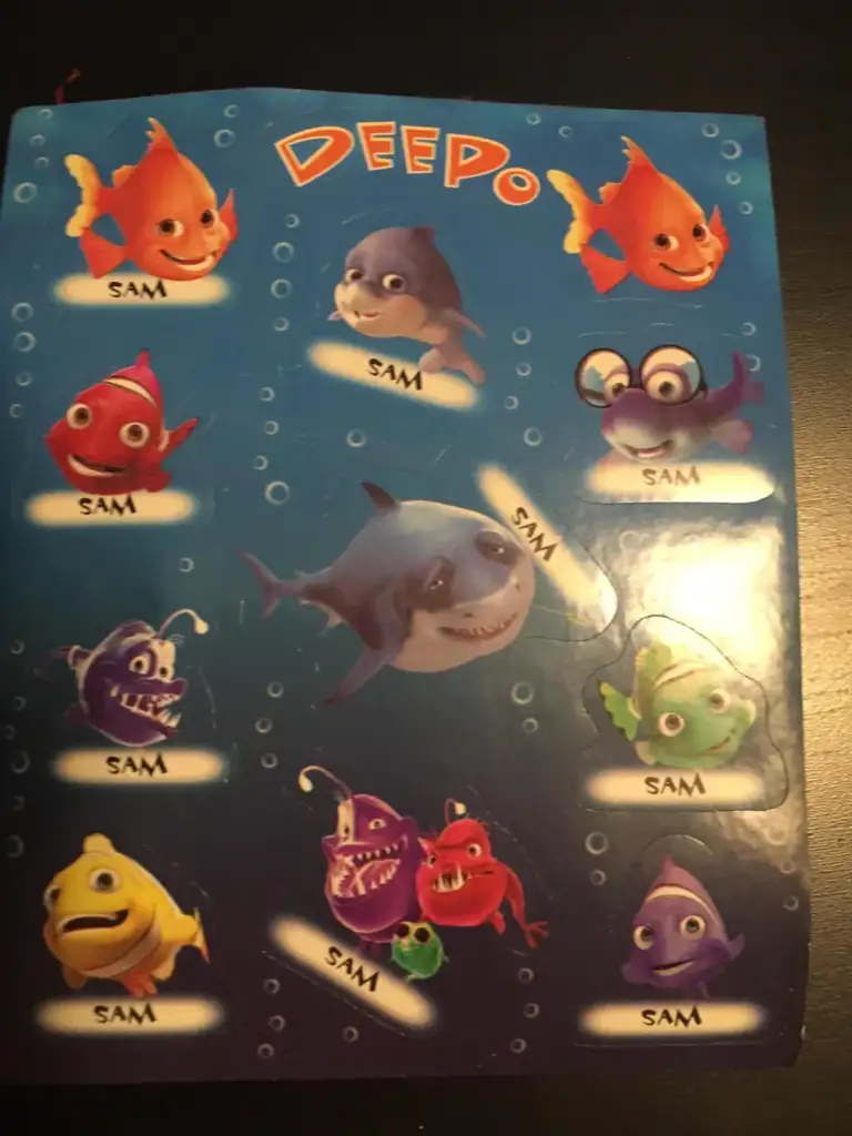 A sheet of stickers featuring cartoon fish and sea creatures from "Deepo." Each character is named "Sam" and includes a variety of colorful fish, a shark, and an octopus, all on a blue background with bubble patterns.