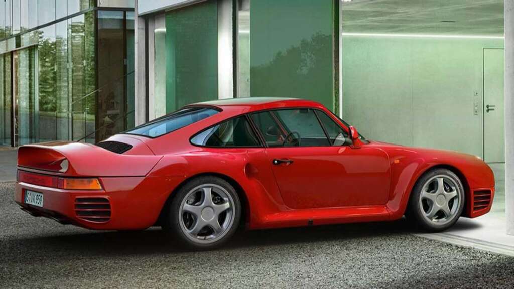 A red sports car with a sleek design is parked next to a modern glass building. Reminiscent of the coolest cars from the 1980s, it boasts a distinctive rear wing and large wheels, highlighting its aerodynamic build.