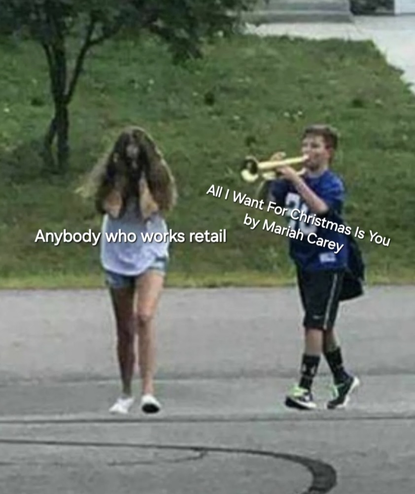 A boy in a blue shirt and shorts plays a trumpet while walking behind a girl with her hands over her ears. The image is captioned: "Anybody who works retail" and "All I Want For Christmas Is You by Mariah Carey.